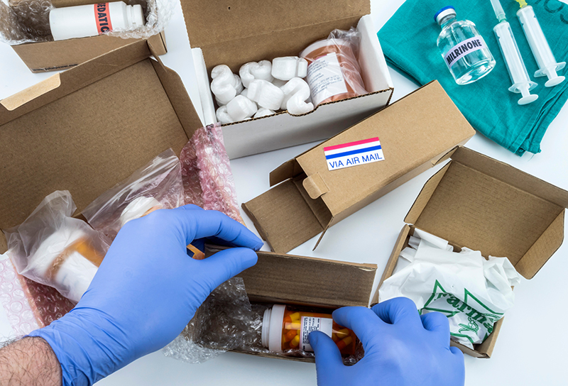 Nurse unpacking medication in boxes, Diverse medicines in boxes for humanitarian aid, conceptual image